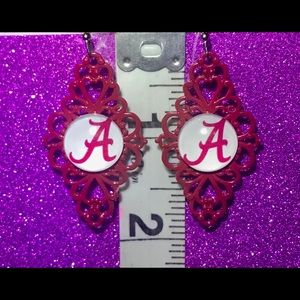 Metal lace Crimson Alabama Crimson Logo earrings.